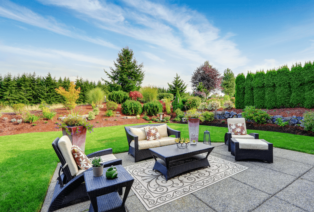 cozy couch in a patio with a beautiful landscaping